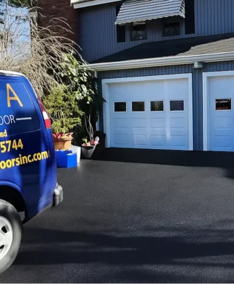 Triple A Garage Doors service van and newly installed white double garage doors in Weston, MA