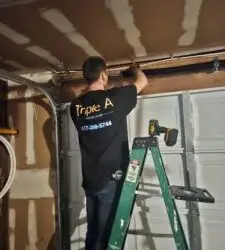 Triple A technician replacing residential garage door opener motor and springs