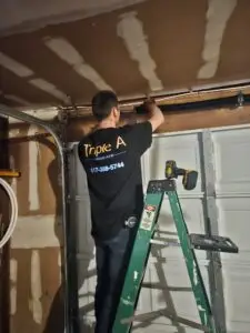 Triple A technician replacing residential garage door opener motor and springs