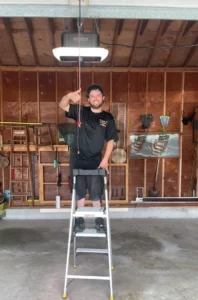 Garage door technician after completing garage door opener installation