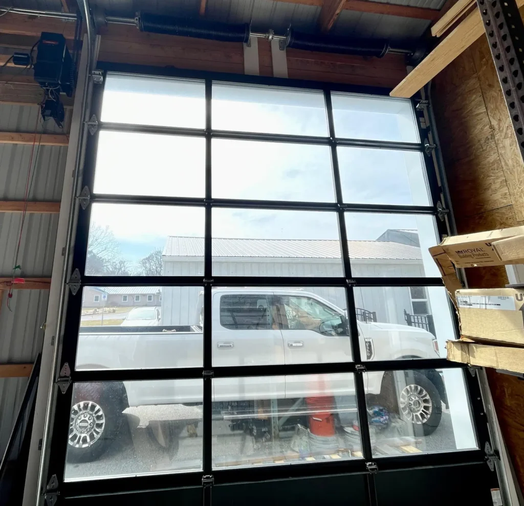 Interior View Of A Modern Glass Commercial Garage Door With Aluminum Frame, Installed By Triple A Garage Door In Massachusetts