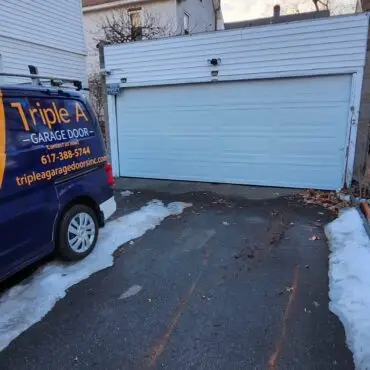 Triple A Garage Door service van parked in front of a residential homeTriple A Garage Door service van parked in front of a residential home