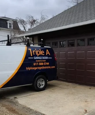 Triple A Garage Doors van beside modern brown garage door installation project in Massachusetts