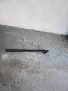 Broken Extension Spring and Safety Cable Repair in Natick, MA 1 Removed Broken Extension Spring After Failure