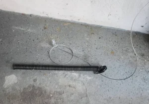 Broken Extension Spring and Safety Cable Repair in Natick, MA 1 Removed Broken Extension Spring After Failure