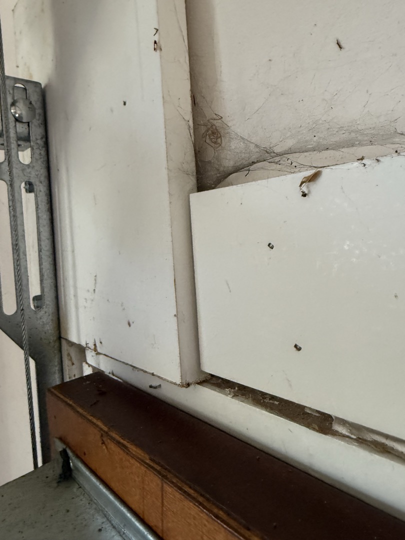 Interior Wood Board Beside The Garage Door Track During Inspection