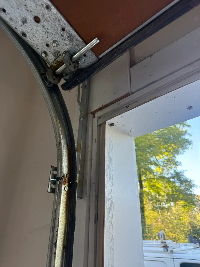 Curved Garage Door Track And Roller Hardware During A Lexington Service Visit